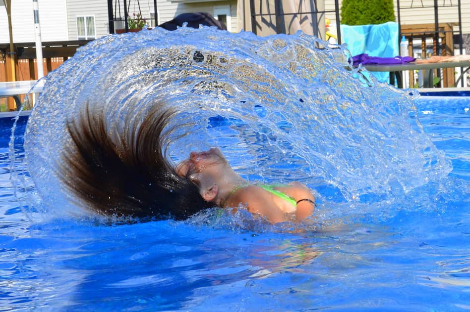 girl flipping her hair back in the pool