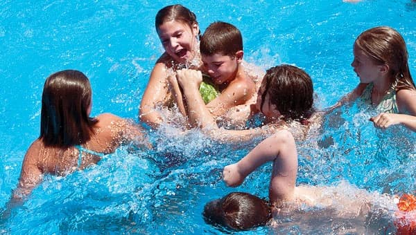 kids playing greased watermelon in the pool